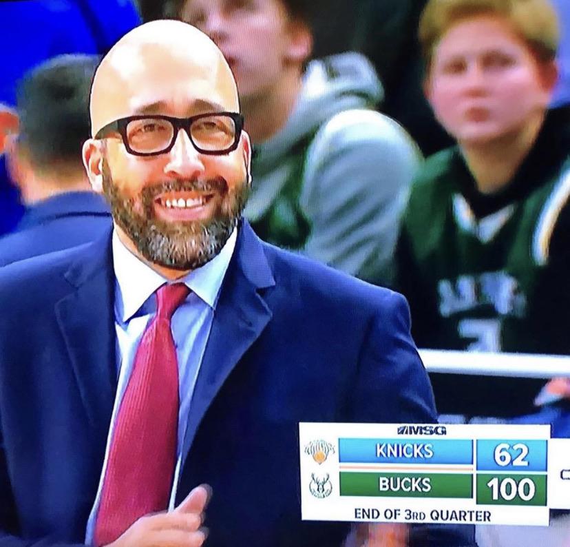 Former Knicks coach of the future. David Fizdale smiling as his team is down 38 points to the Bucks in the beginning of the 2019-20 season. Pictured here.